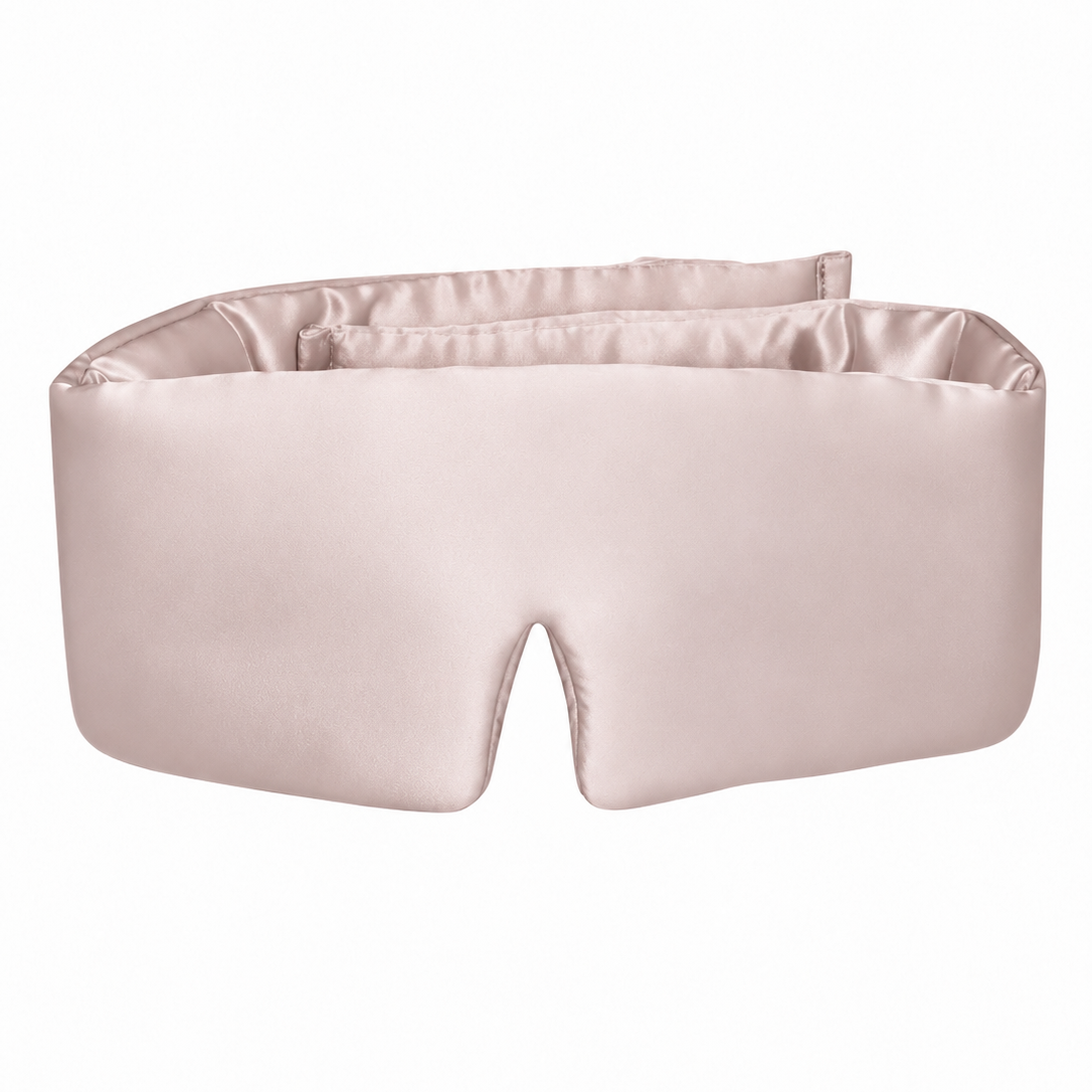 Rose pink wraparound silk sleep mask with a padded shape and a contoured nose opening